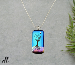 Dichroic Gold Pink Blue Glass Rectangular Pendant with Hand Etched Tree of Life with a Swarovski Crystal Moon Dichroic Gold Pink Blue Glass Rectangular Pendant with Hand Etched Tree of Life with a Swarovski Crystal Moon