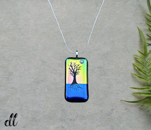Dichroic Yellow Pink Blue Glass Rectangular Pendant with Hand Etched Tree of Life with a Swarovski Crystal Moon Dichroic Yellow Pink Blue Glass Rectangular Pendant with Hand Etched Tree of Life with a Swarovski Crystal Moon