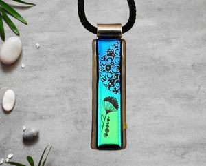 Fused Glass Blue and Green Dichroic Long and Narrow Rectangular Pendant Etched with Mandala Designs on a Black/Clear base Fused Glass Blue and Green Dichroic Long and Narrow Rectangular Pendant Etched with Mandala Designs on a Black/Clear base