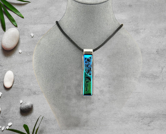 Fused Glass Blue and Green Dichroic Long and Narrow Rectangular Pendant Etched with Mandala Designs on a Black/Clear base